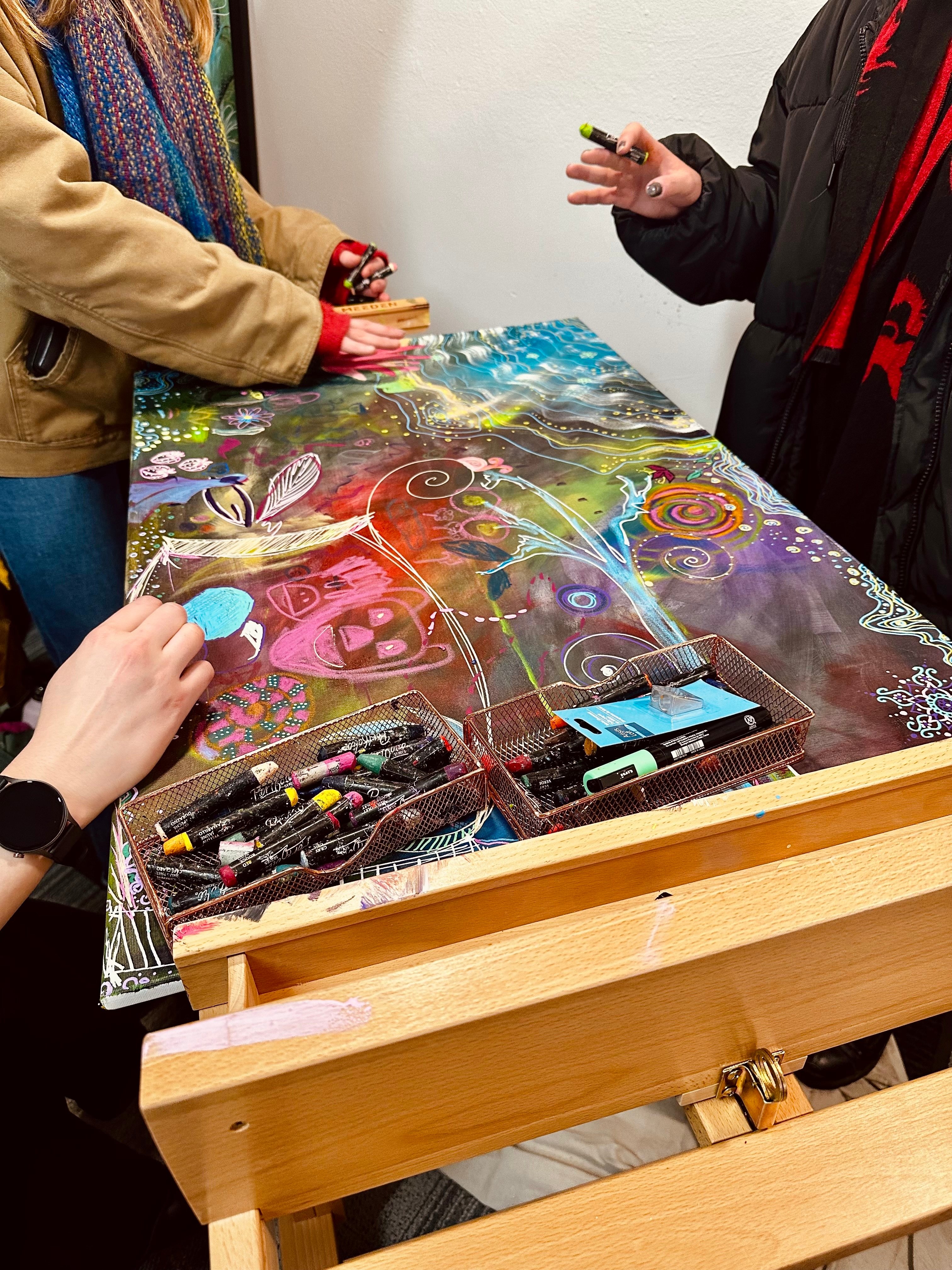 community members collaborate on a painting
